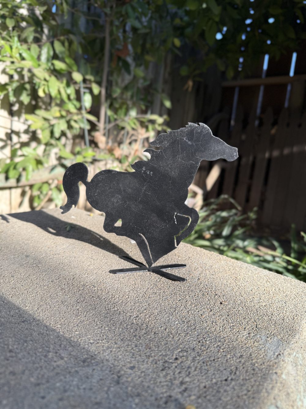 A running horse cut from steel.