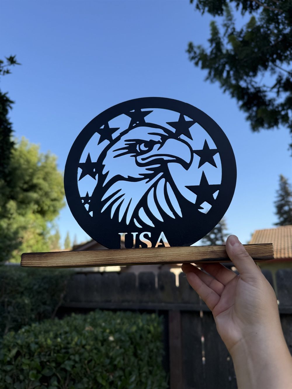 An eagle and stars cut in a steel circle above USA.